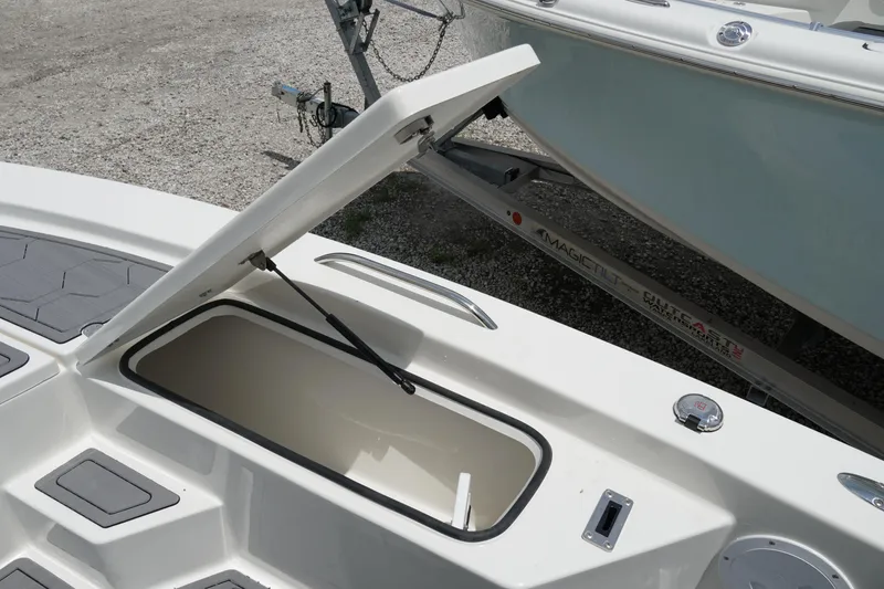 Slide: The Image of 2026 May-Craft 220 Bay boat with open storage compartment on deck. - 26