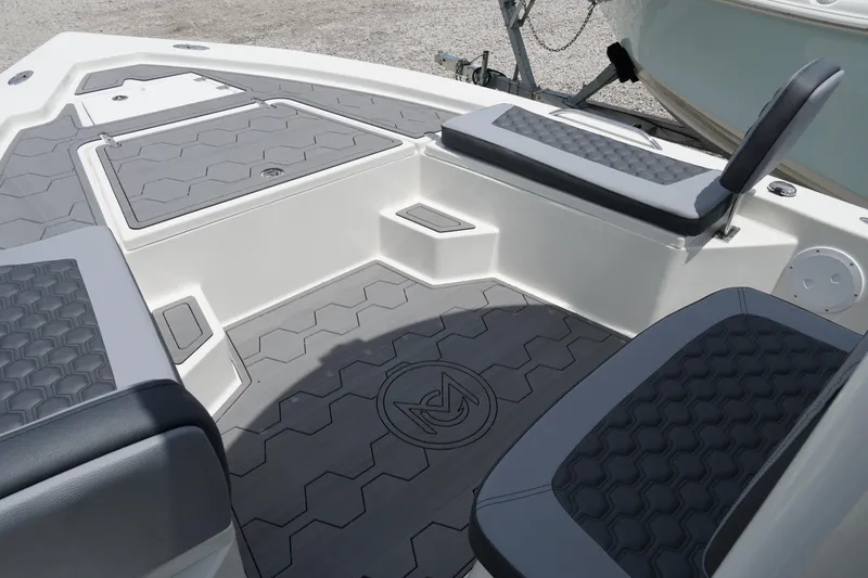 Slide: The Image of 2026 May-Craft 220 Bay boat interior with gray seating and textured flooring. - 28