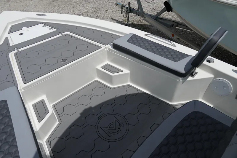 Slide: The Image of 2026 May-Craft 220 Bay boat interior with hexagonal pattern flooring and seating. - 29