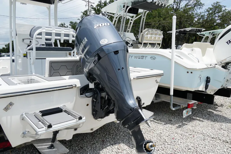 Slide: The Image of 2026 May-Craft 220 Bay boat with Yamaha 200 outboard motor, displayed outdoors. - 35