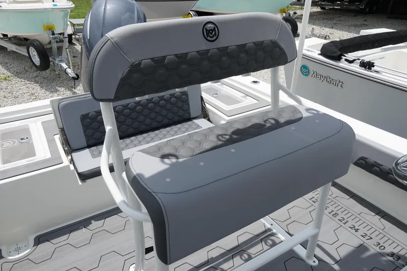 Slide: The Image of 2026 May-Craft 220 Bay boat interior with gray seating and hexagonal pattern design. - 5