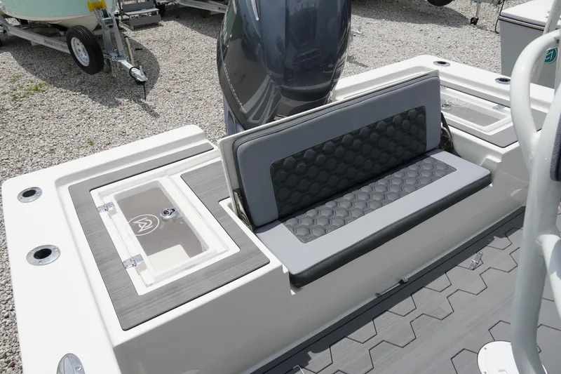 Slide: The Image of 2026 May-Craft 220 Bay boat interior with cushioned seating and storage compartments. - 6