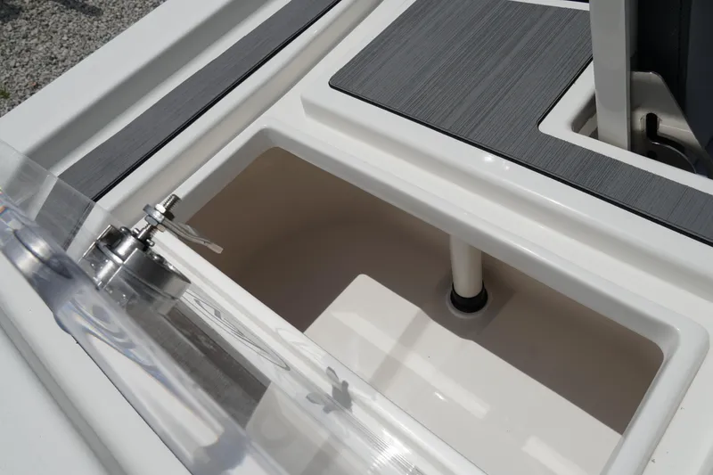Slide: The Image of 2026 May-Craft 220 Bay boat storage compartment with open lid and sleek design. - 9