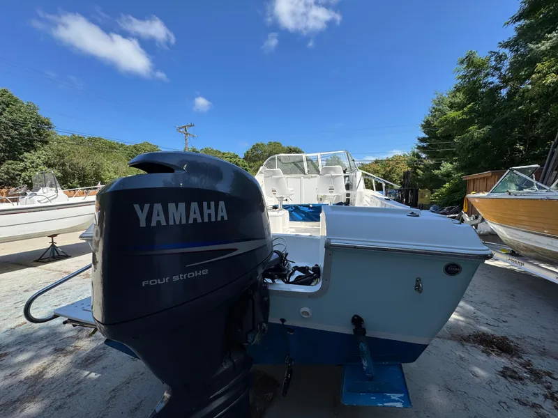 Slide: The Image of 2011 Clearwater 21 WAC boat with Yamaha four-stroke engine, parked outdoors. - 3