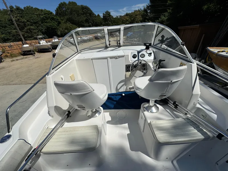 Slide: The Image of Interior of a 2011 Clearwater 21 WAC boat with dual seats and steering console. - 7