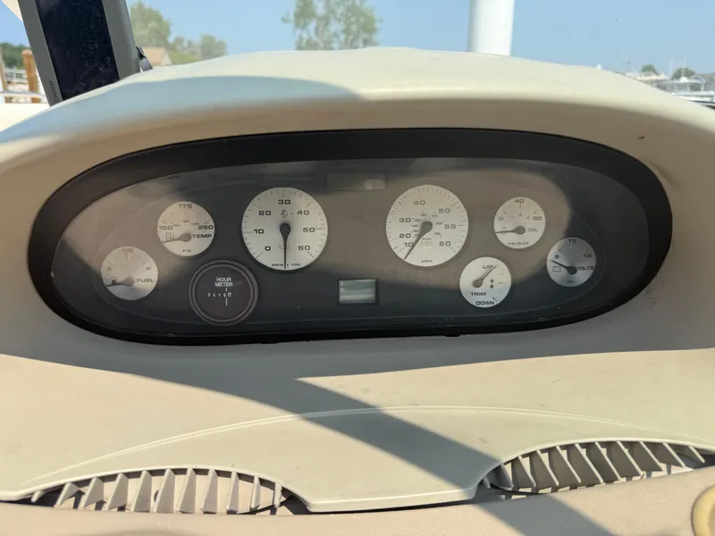 Slide: The Image of Dashboard of a 1999 Bayliner 2350 Capri SS boat with gauges and controls. - 10