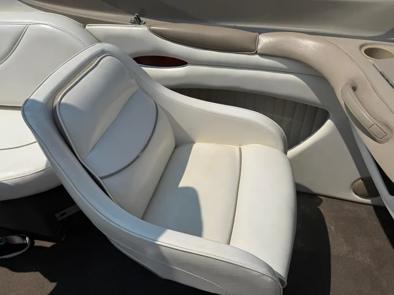 Slide: The Image of White leather seat in a 1999 Bayliner 2350 Capri SS boat interior. - 12