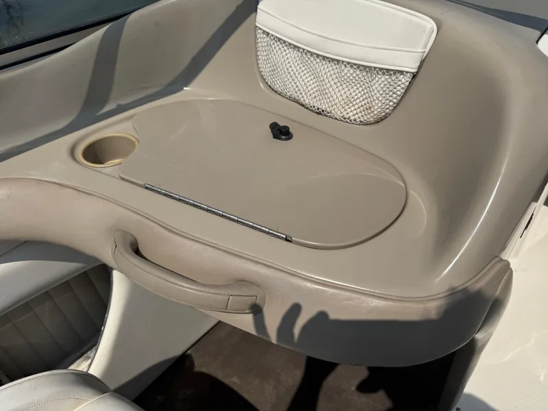 Slide: The Image of Interior of 1999 Bayliner 2350 Capri SS boat with beige seating and storage compartment. - 13