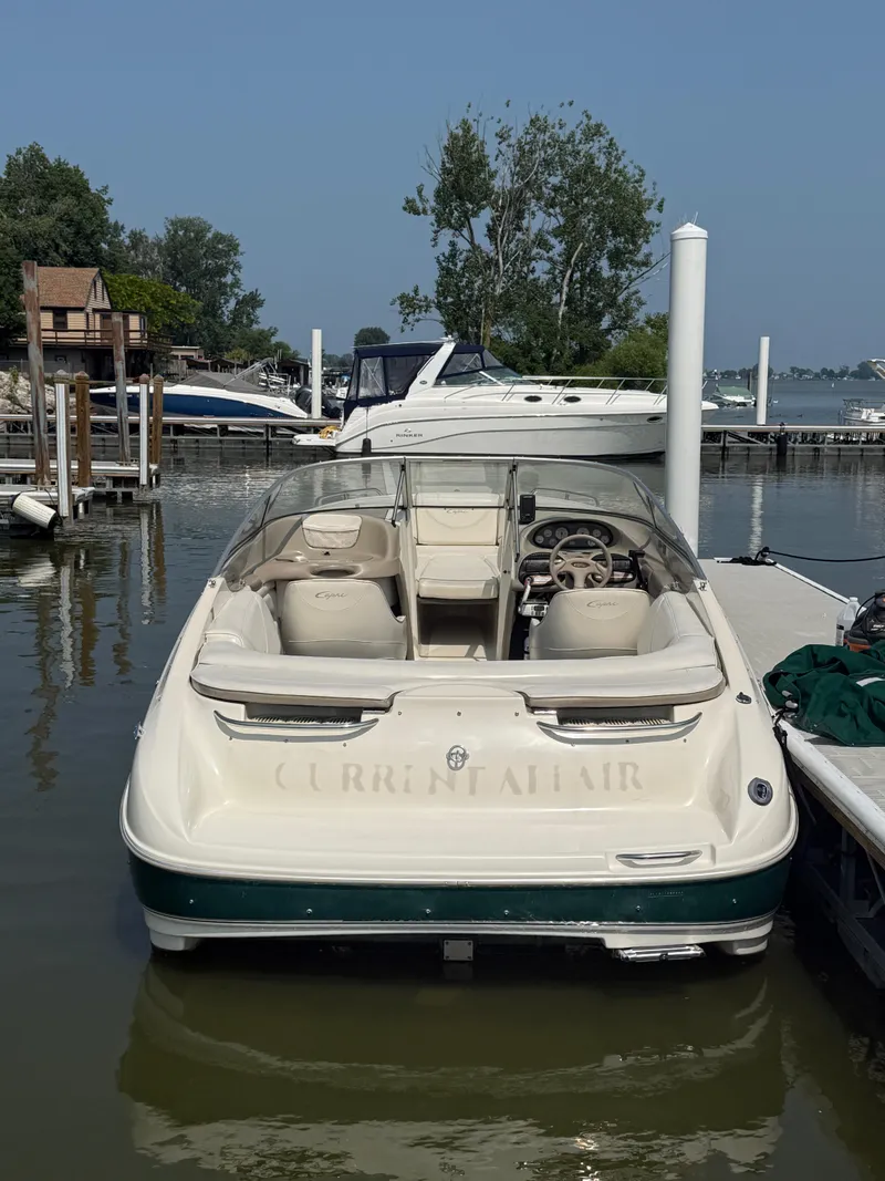 Slide: The Image of 1999 Bayliner 2350 Capri SS boat docked at marina, rear view. - 16