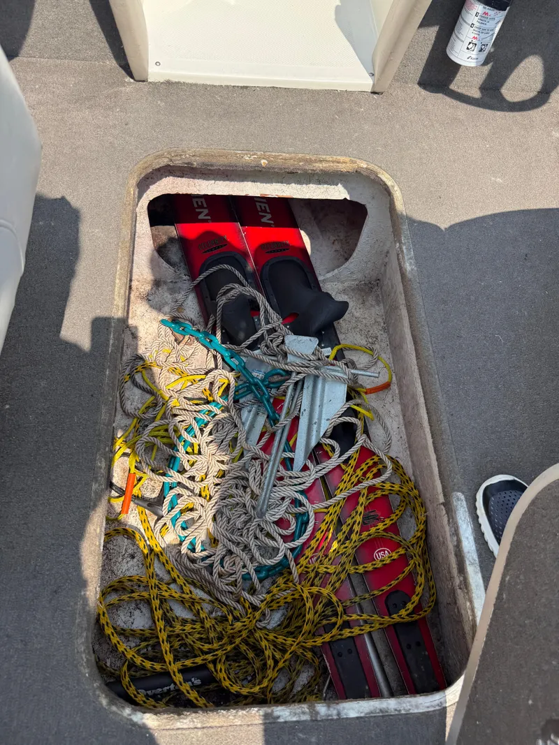 Slide: The Image of Storage compartment in a 1999 Bayliner 2350 Capri SS with water skis and ropes. - 19