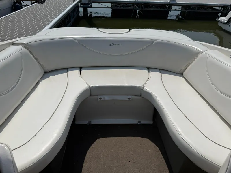Slide: The Image of 1999 Bayliner 2350 Capri SS boat interior with white cushioned seating. - 3
