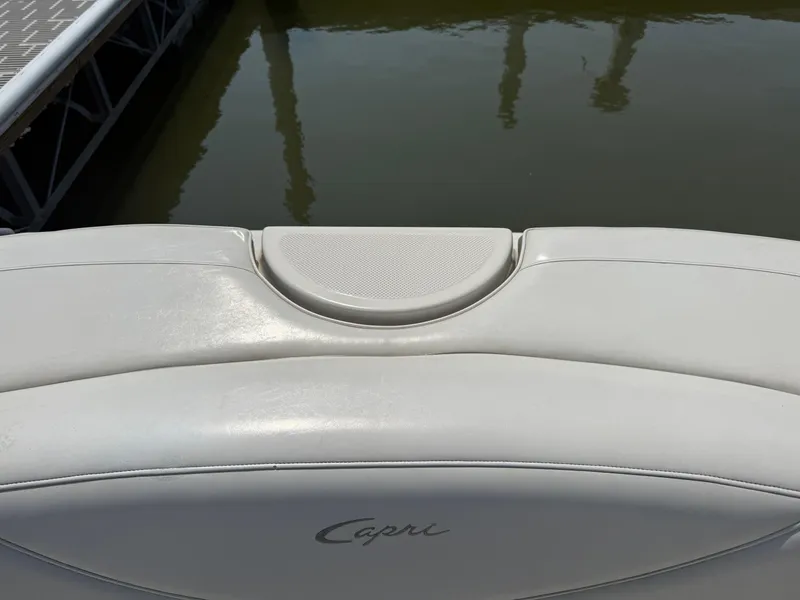 Slide: The Image of 1999 Bayliner 2350 Capri SS boat seat with water and dock background. - 5