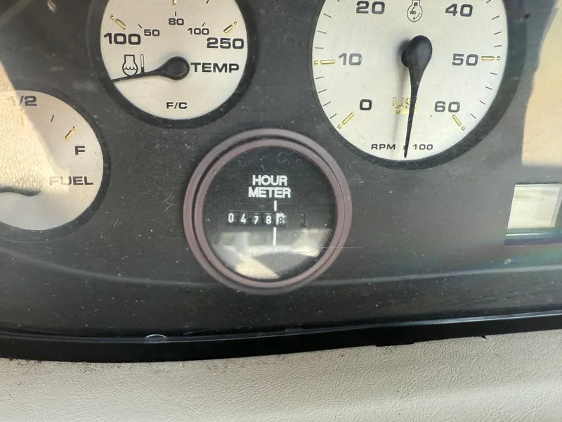 Slide: The Image of Dashboard of 1999 Bayliner 2350 Capri SS showing hour meter and gauges. - 8