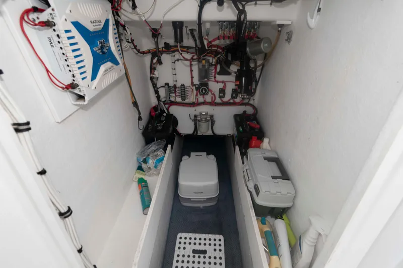Slide: The Image of Interior of 2023 Rambo 27 Center Console boat showing electrical components and storage. - 12