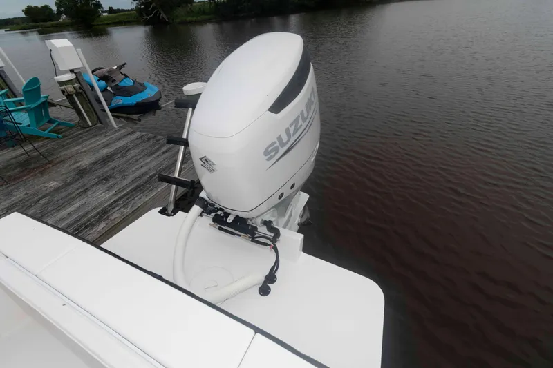 Slide: The Image of 2023 Rambo 27 Center Console boat with Suzuki outboard motor by a dock. - 13