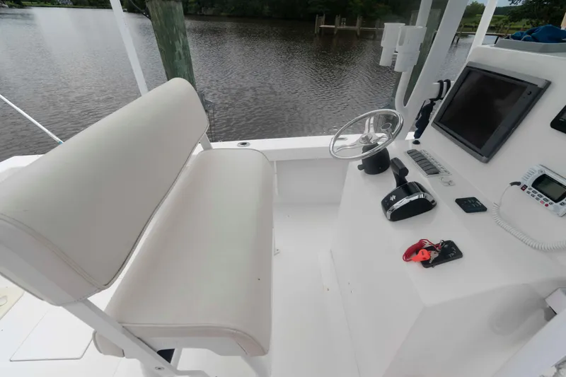 Slide: The Image of 2023 Rambo 27 Center Console boat interior with steering wheel and controls. - 6