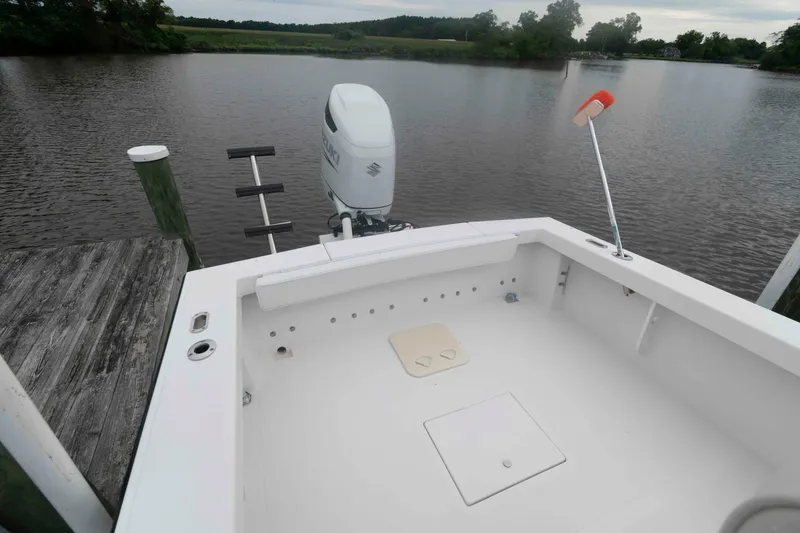 Slide: The Image of 2023 Rambo 27 Center Console boat docked by a serene lake. - 9