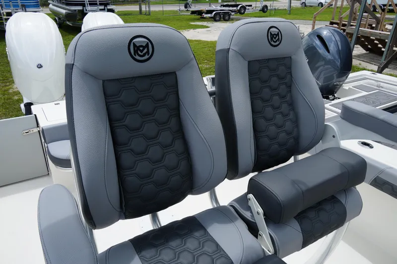 Slide: The Image of 2026 May-Craft 245 Offshore CC boat seats with hexagonal pattern and logo. - 2