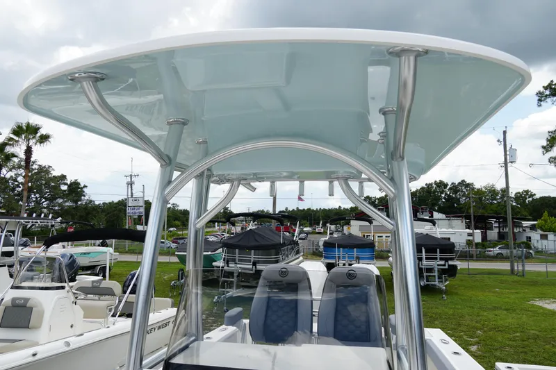 Slide: The Image of 2026 May-Craft 245 Offshore CC boat with T-top, displayed outdoors. - 20