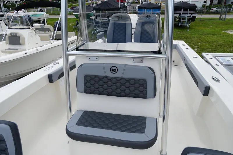 Slide: The Image of 2026 May-Craft 245 Offshore CC boat interior with cushioned seating and sleek design. - 21