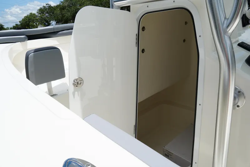 Slide: The Image of 2026 May-Craft 245 Offshore CC boat, open storage compartment, white interior, sleek design. - 28
