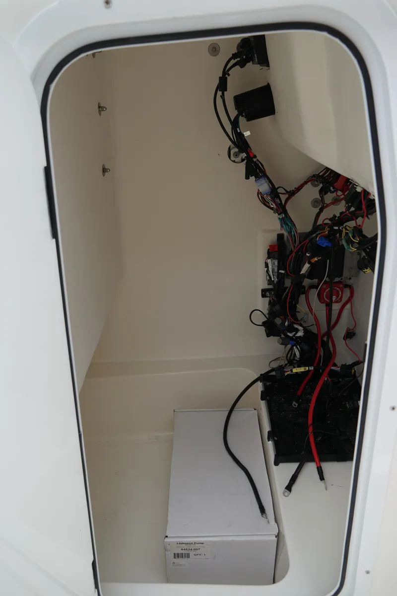 Slide: The Image of Electrical compartment of 2026 May-Craft 245 Offshore CC boat, showing wiring and components. - 30