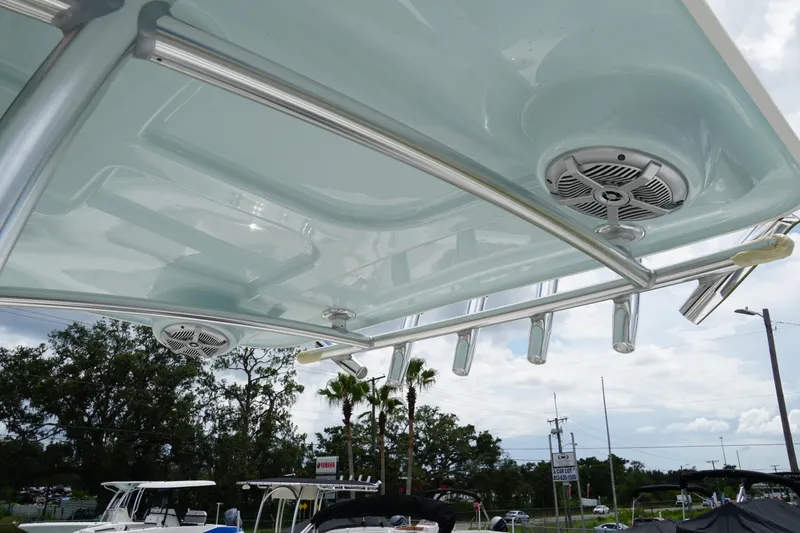 Slide: The Image of T-top of 2026 May-Craft 245 Offshore CC boat with speakers and rod holders. - 32