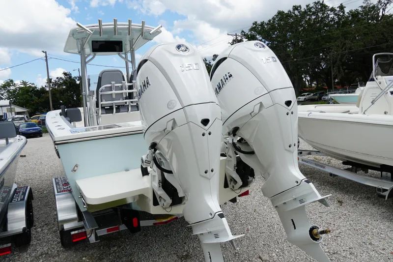 Slide: The Image of 2026 May-Craft 245 Offshore CC boat with dual Yamaha outboard engines, parked on a trailer. - 35