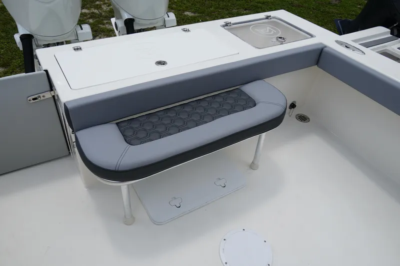 Slide: The Image of 2026 May-Craft 245 Offshore CC boat with cushioned seating and storage compartments. - 4