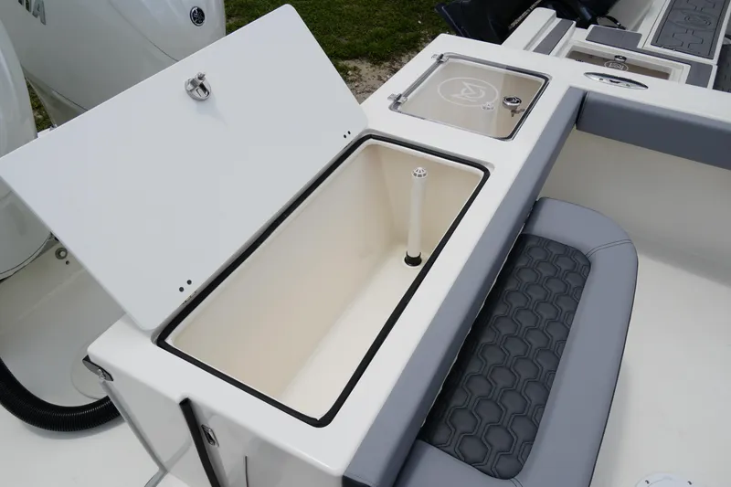 Slide: The Image of 2026 May-Craft 245 Offshore CC boat storage compartment and seating detail. - 8