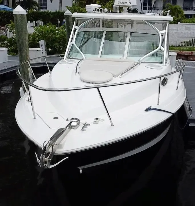 Slide: The Image of 2014 Wellcraft 340 Coastal boat docked, featuring sleek design and spacious deck. - 1