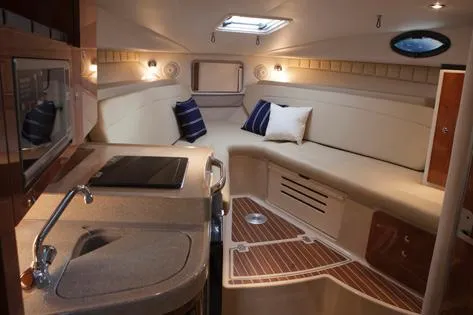 Slide: The Image of Manufacturer Provided Image: Interior of 2014 Wellcraft 340 Coastal boat with cozy seating and kitchenette. - 12