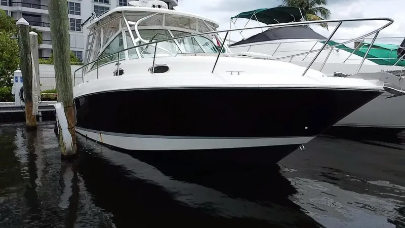 Slide: The Image of 2014 Wellcraft 340 Coastal boat docked in marina, side view. - 3