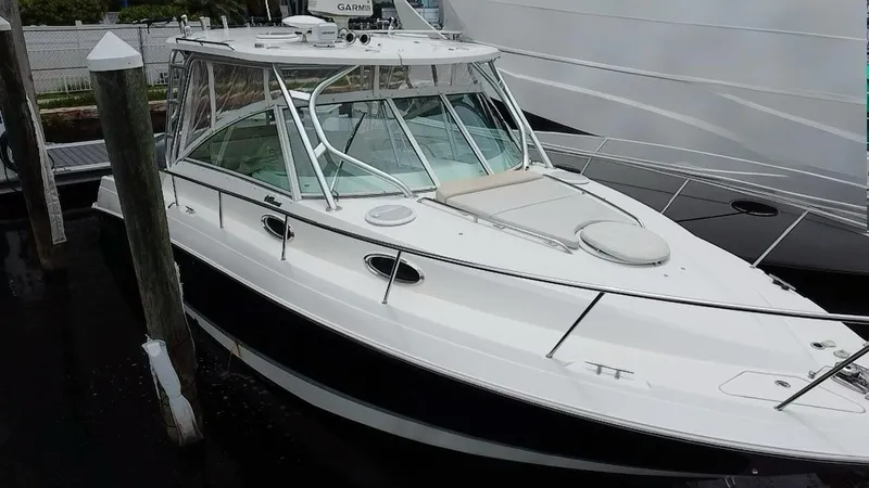 Slide: The Image of 2014 Wellcraft 340 Coastal boat docked, featuring sleek design and spacious deck. - 4