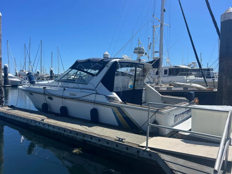 Slide: The Image of 1987 Trojan Sunbridge Express boat docked at marina under clear blue sky. - 1