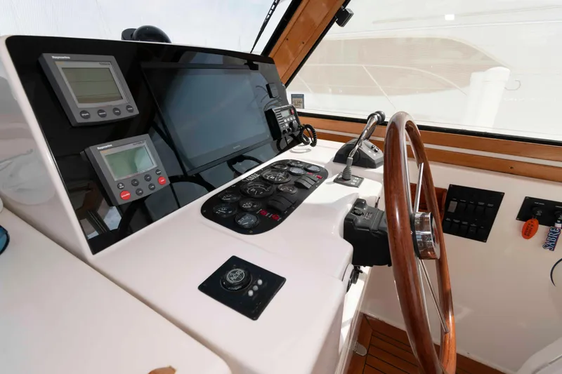 Slide: The Image of Helm of 2003 Sabre 42 Express yacht with navigation instruments and wooden steering wheel. - 12