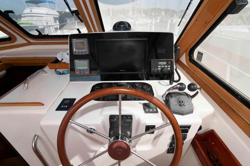 Slide: The Image of Helm of 2003 Sabre 42 Express yacht with steering wheel and navigation equipment. - 13