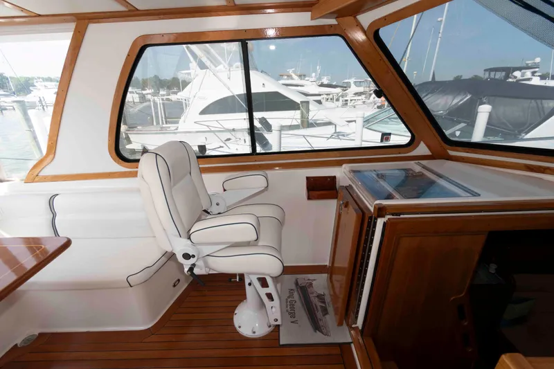 Slide: The Image of Interior of 2003 Sabre 42 Express yacht with white seating and wooden accents. - 14