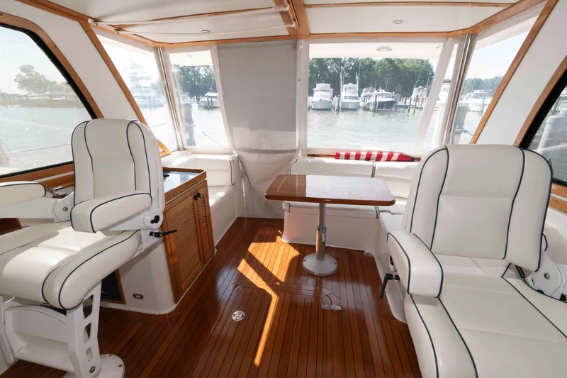 Slide: The Image of Interior of 2003 Sabre 42 Express yacht with white seating and wooden flooring. - 15