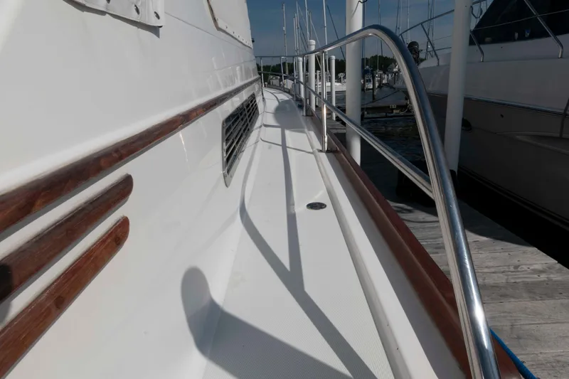 Slide: The Image of 2003 Sabre 42 Express yacht deck with wooden accents and metal railings. - 16