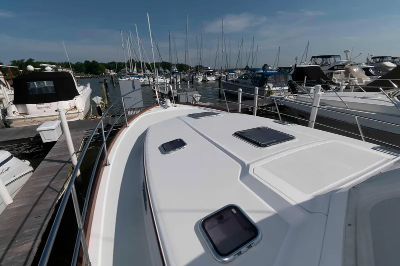 Slide: The Image of 2003 Sabre 42 Express yacht docked at a marina, surrounded by other boats. - 17