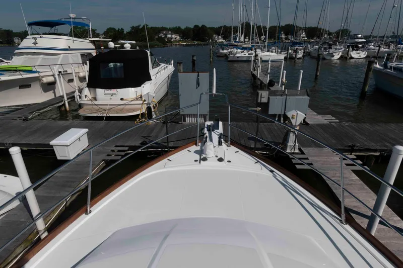 Slide: The Image of Bow view of 2003 Sabre 42 Express yacht docked at marina with other boats. - 19