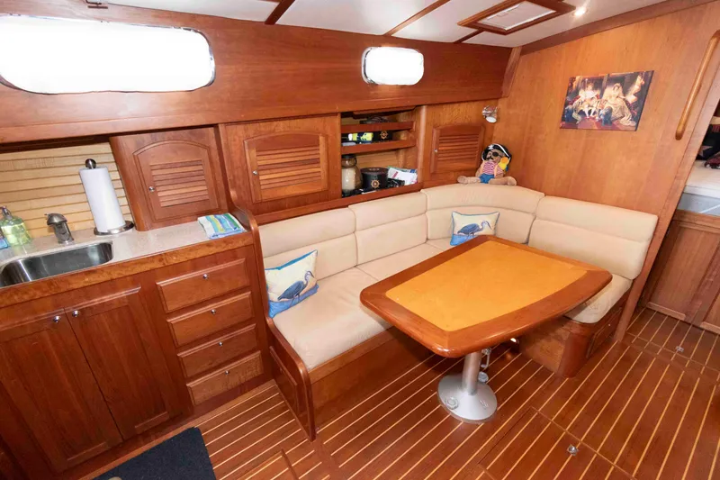 Slide: The Image of Interior of 2003 Sabre 42 Express yacht with wooden cabinetry and cozy seating area. - 21