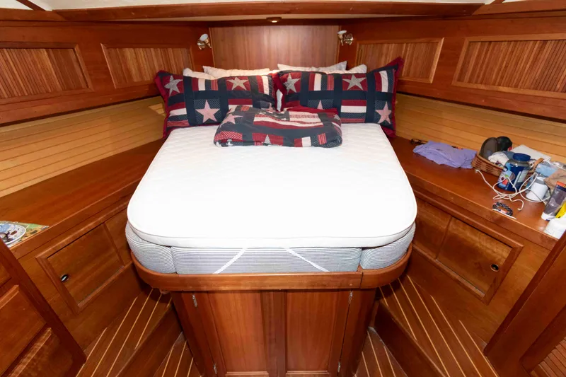 Slide: The Image of Cozy cabin interior of 2003 Sabre 42 Express with wooden finish and star-patterned bedding. - 25
