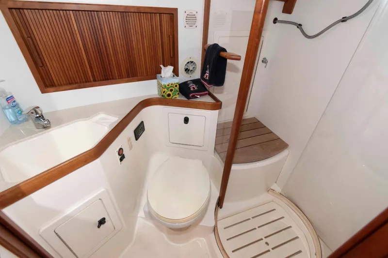 Slide: The Image of 2003 Sabre 42 Express yacht bathroom with wooden accents and modern fixtures. - 27