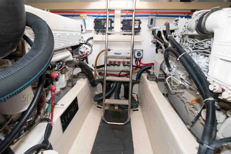 Slide: The Image of Engine room of 2003 Sabre 42 Express boat, featuring complex machinery and wiring. - 28