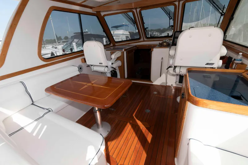 Slide: The Image of Interior of 2003 Sabre 42 Express yacht with wooden flooring and white seating. - 7