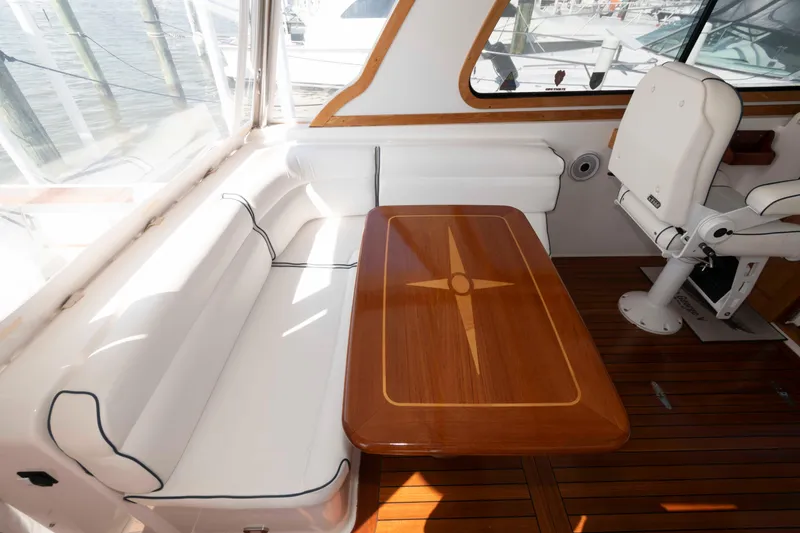 Slide: The Image of 2003 Sabre 42 Express yacht interior with white seating and wooden table. - 8