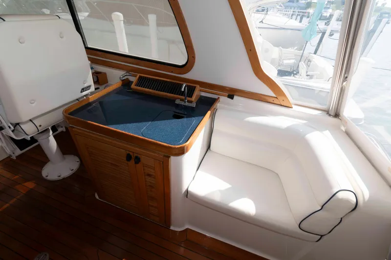Slide: The Image of 2003 Sabre 42 Express yacht interior with seating and wooden cabinetry. - 9