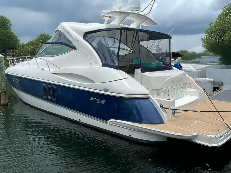 Slide: The Image of 2005 Cruisers Yachts 500 Express docked, featuring sleek design and spacious deck. - 7